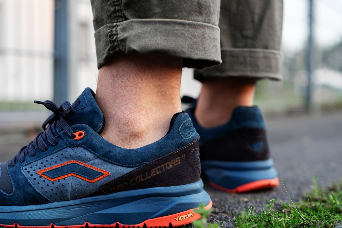 Blue sneakers standing on paved ground