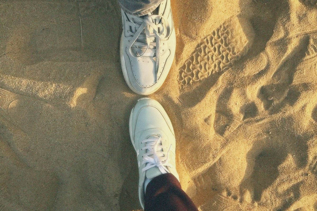 Footwear resting on sandy beach ground at a coastal town