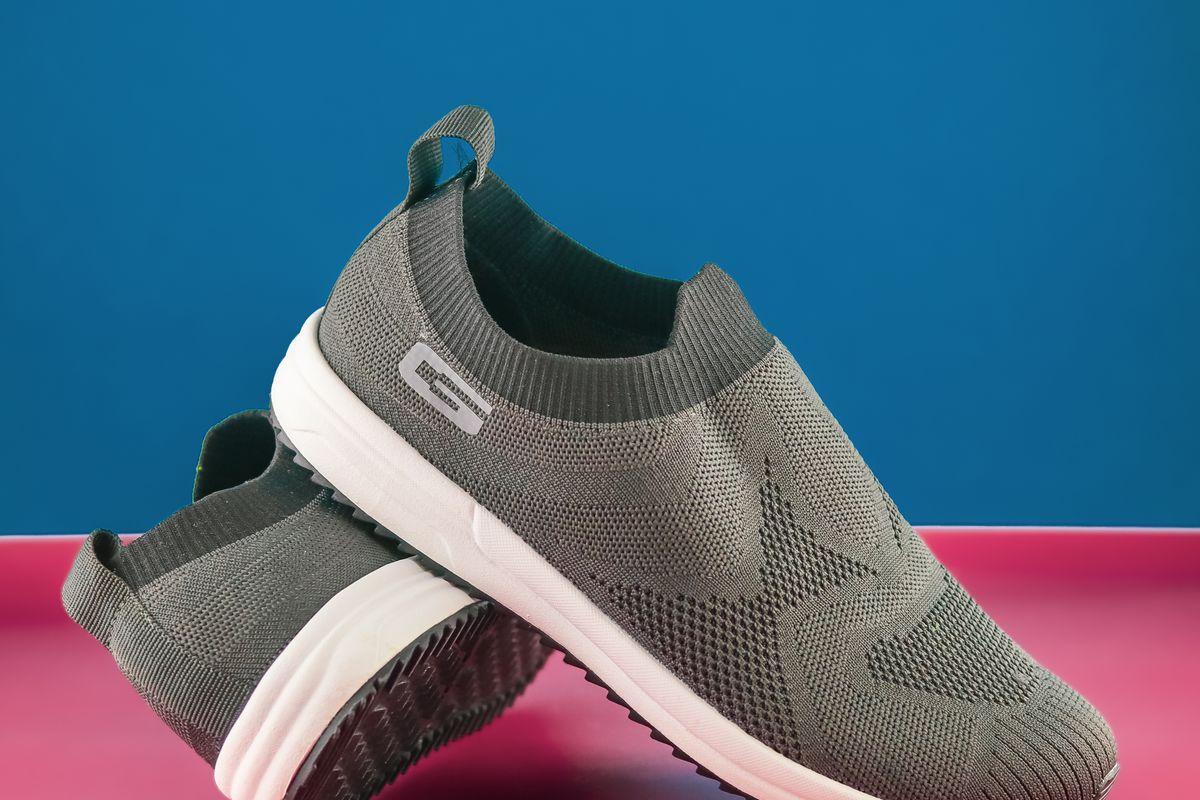 Gray walking shoes on a neutral background
