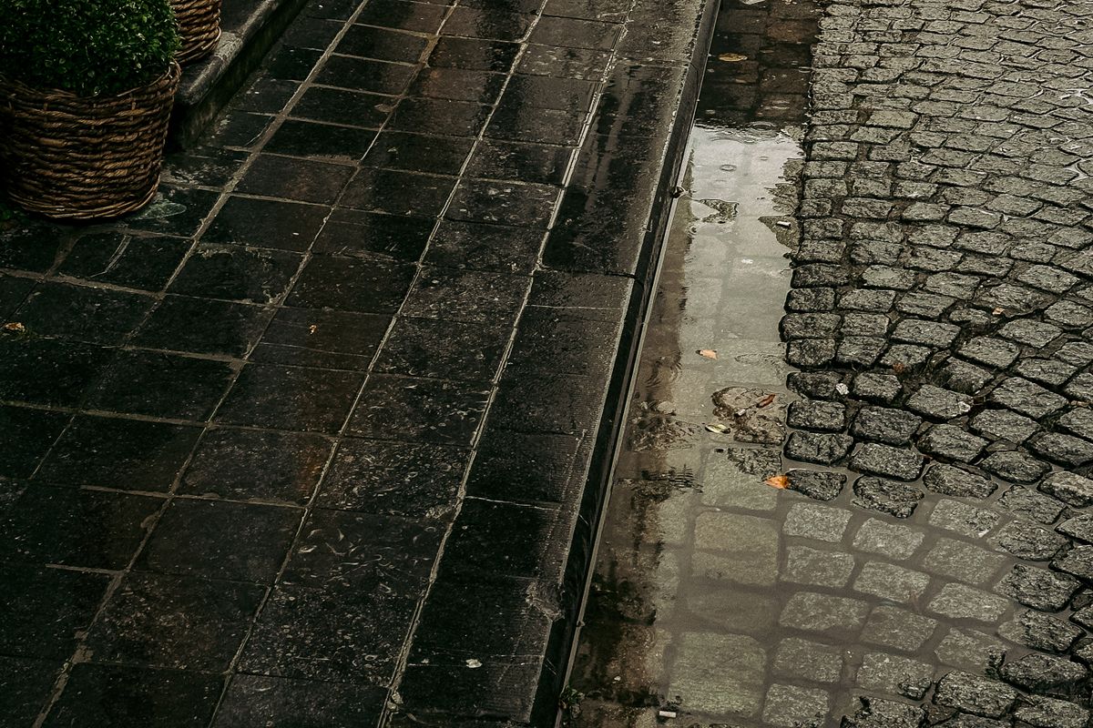 Rain falling on a cobblestone street in Bruges